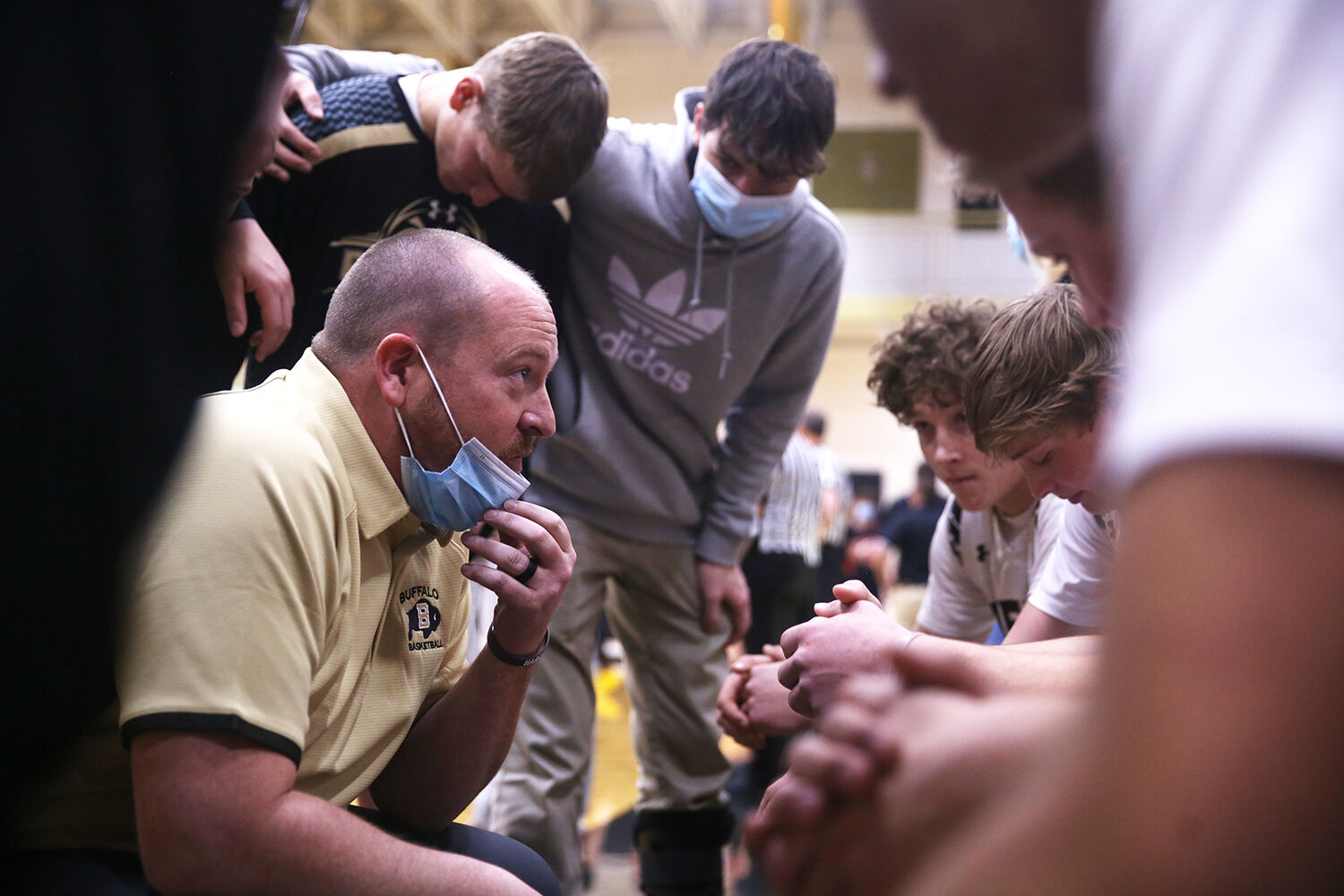Tanner Hart huddles with the starters while the visiting team
